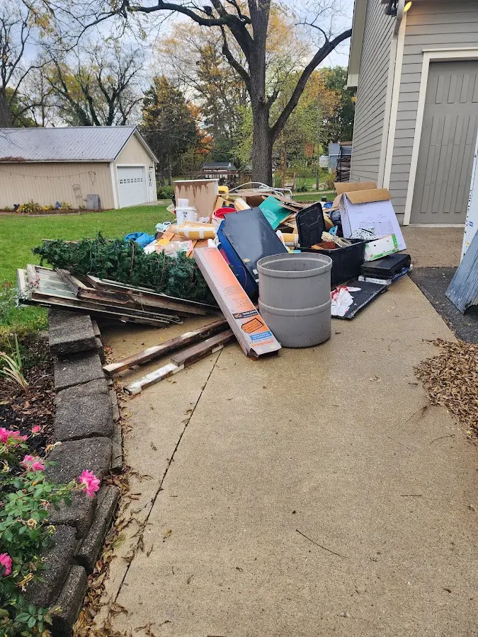 Dumpster being loaded with debris for Estate Cleanout Dumpster Rental in DeSoto
